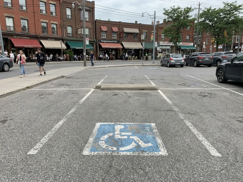 Handicap parking painting Toronto before: faded stall in Little Italy