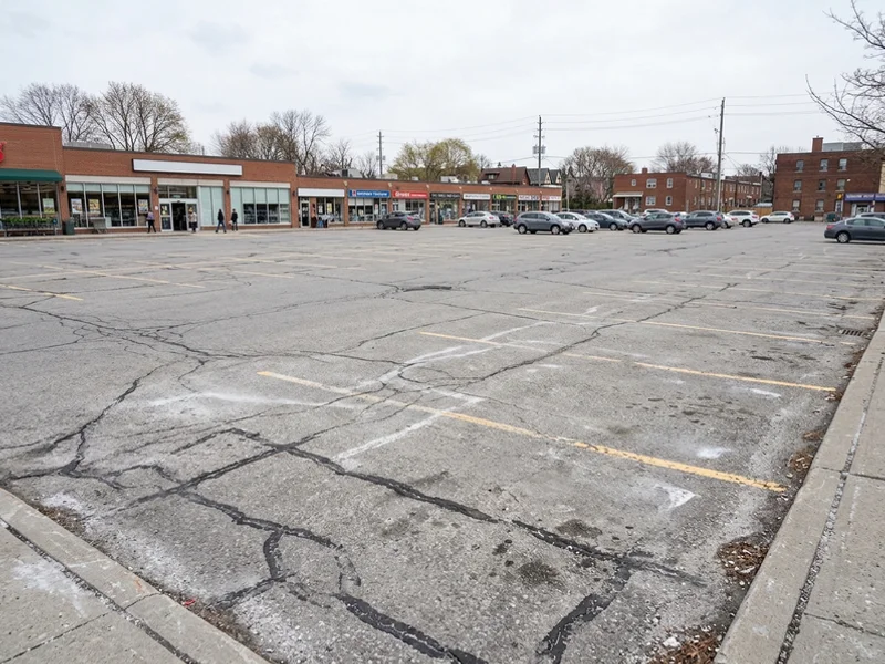 Line painting Toronto before: faded stalls in a Riverdale parking lot
