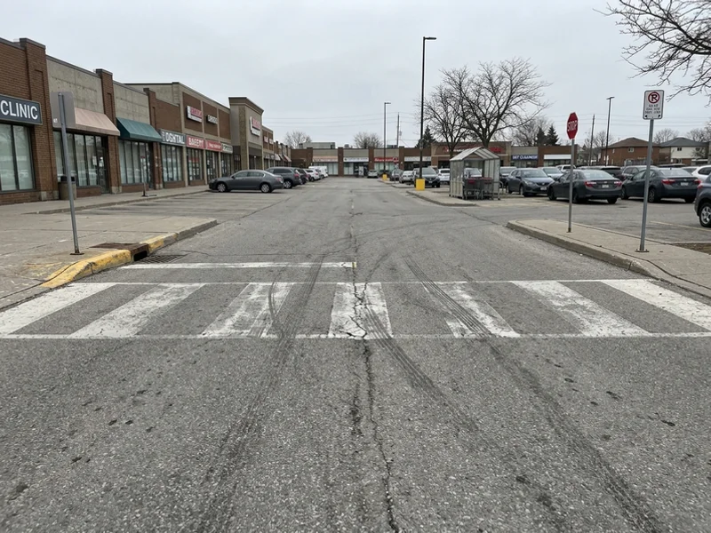 Before crosswalk painting: faded lines in Toronto